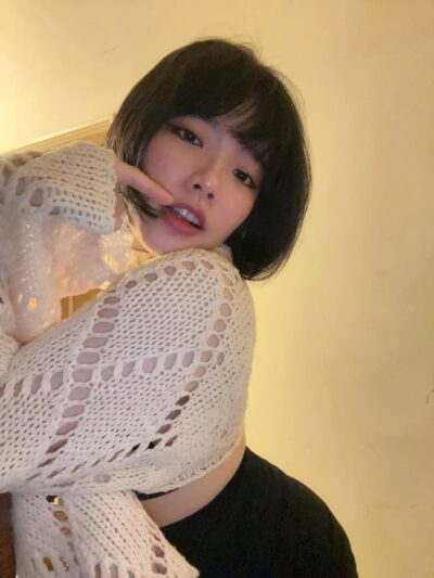 Busty Asian escort posing