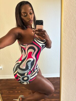 Ebony Blackpool escort in skin tight dress taking a selfie