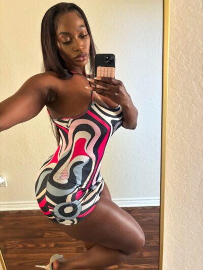 Ebony Blackpool escort in skin tight dress taking a selfie