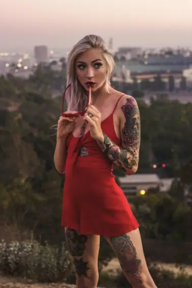 Tattooed blonde Bangor escort in a red dress