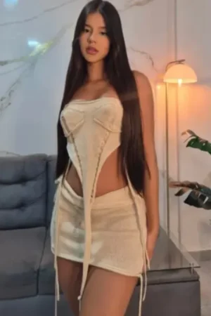Sexy brunette escort in a beige outfit