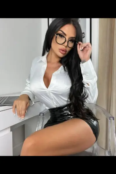 High-class escort in a tight PVC skirt