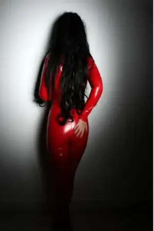 Pornstar escort in red PVC outfit
