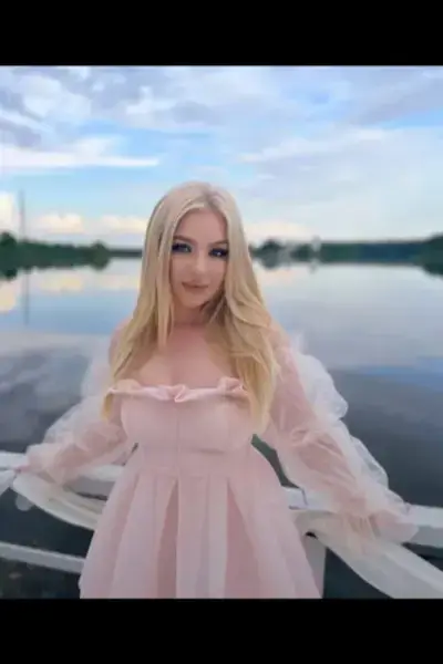 Blonde Plymouth Escort in a light pink dress