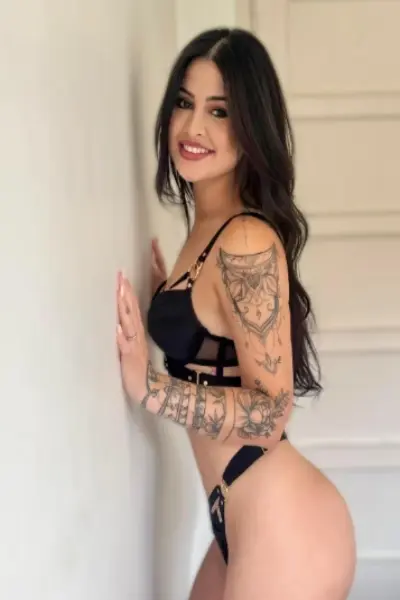 Tattooed Latina Escort in black lingerie