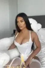 Sexy brunette escort in white lingerie