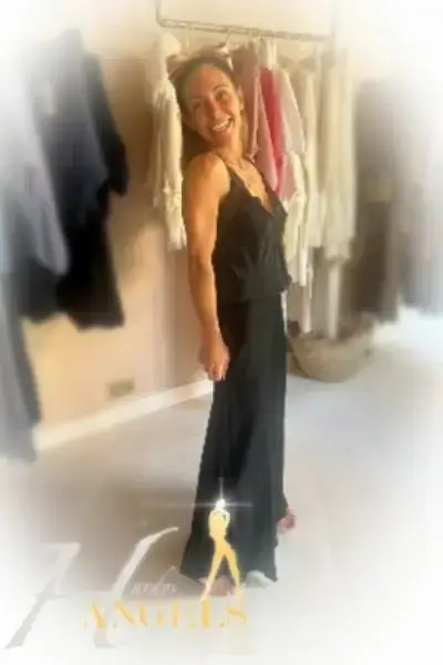 Smiling escort in a black dress