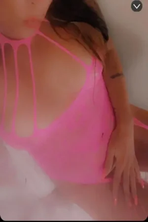 MILF escort in pink swimsuit