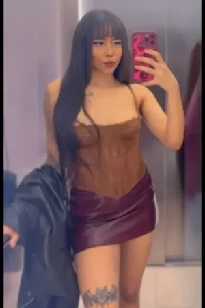 Tattooed Mixed Race Escort in a beige top