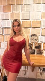 Sexy blonde Dublin escort in a tight red dress