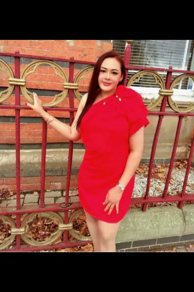 Thai escort weariing a red dress
