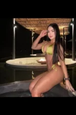 Long haired brunette escort in a hot tub