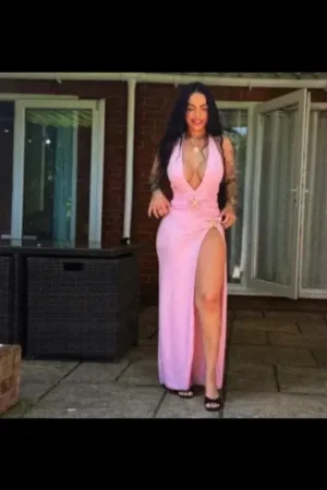 Elstow Escort wearing a long pink dress