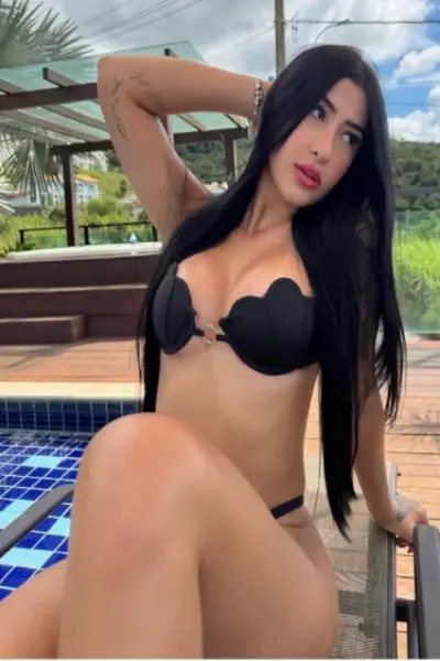 Sexy brunette escort wearing a fashionable black bikini