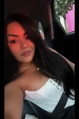 Escort posing in the car