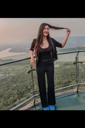 Asian escort posing on a high up balcony