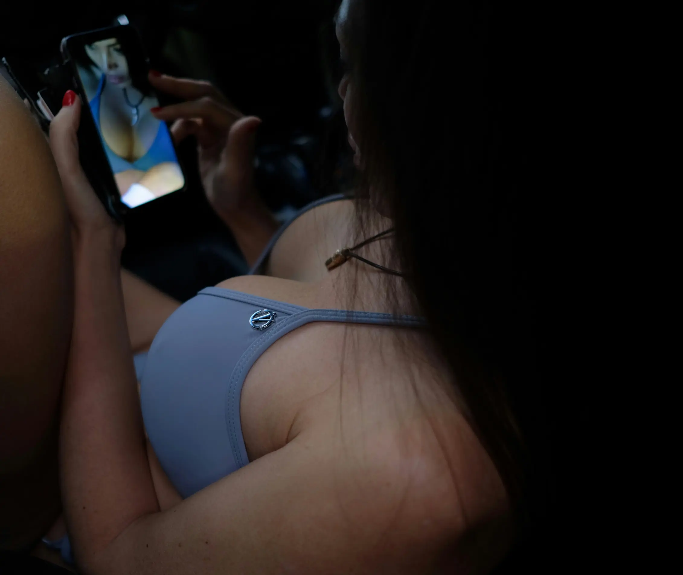 Busty Derry escort playing with her phone