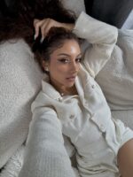 Soton escort sat on the settee holding her hair