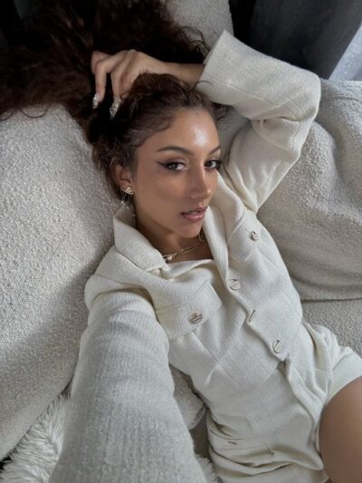 Soton escort sat on the settee holding her hair