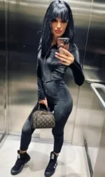 Petite escort taking a selfie in a lift