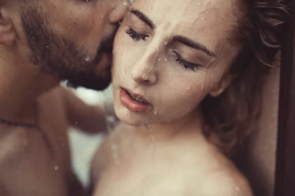 Man and women kissing in the shower