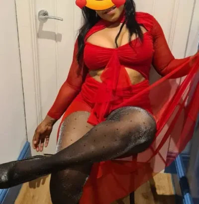 Curvy black escort in a red dress