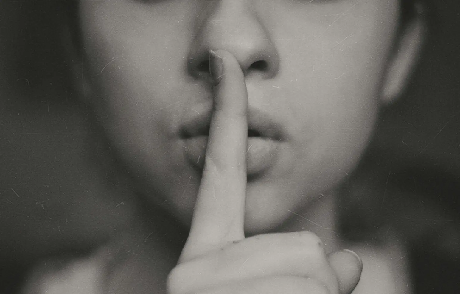 Woman with finger to her lips