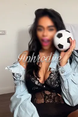 Sexy Cardiff escort holding a football