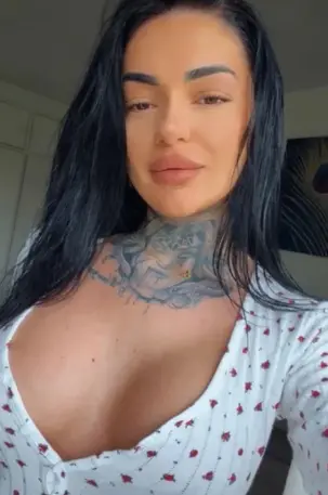 Attractive escort with a neck tattoo