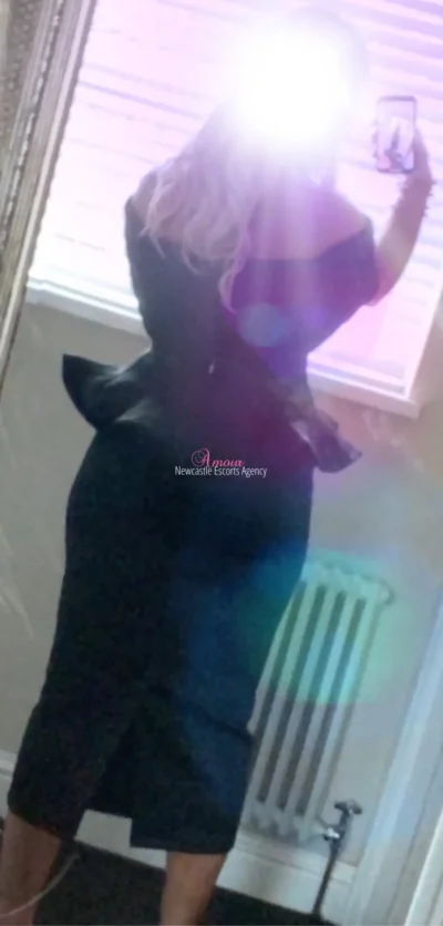 Blonde escort taking a selfie