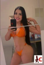 Sexy Colombian Escort takes a selfie in a orange bikini