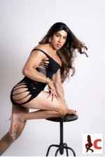 Toned TV escort in a black dress