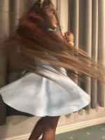 Ebony escort spinning in a dress